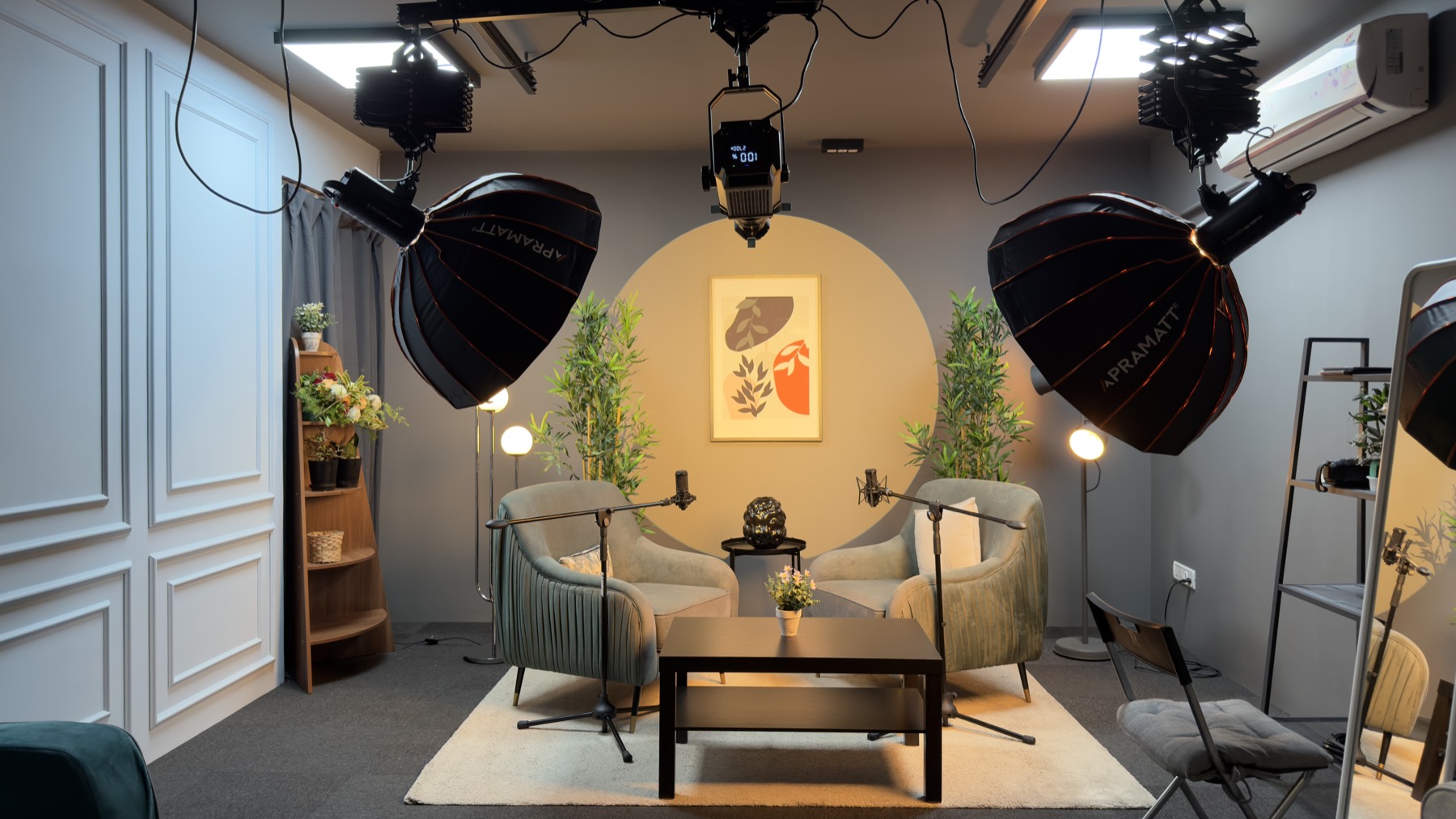 The Amber Arc set — golden circular backdrop with studio lights