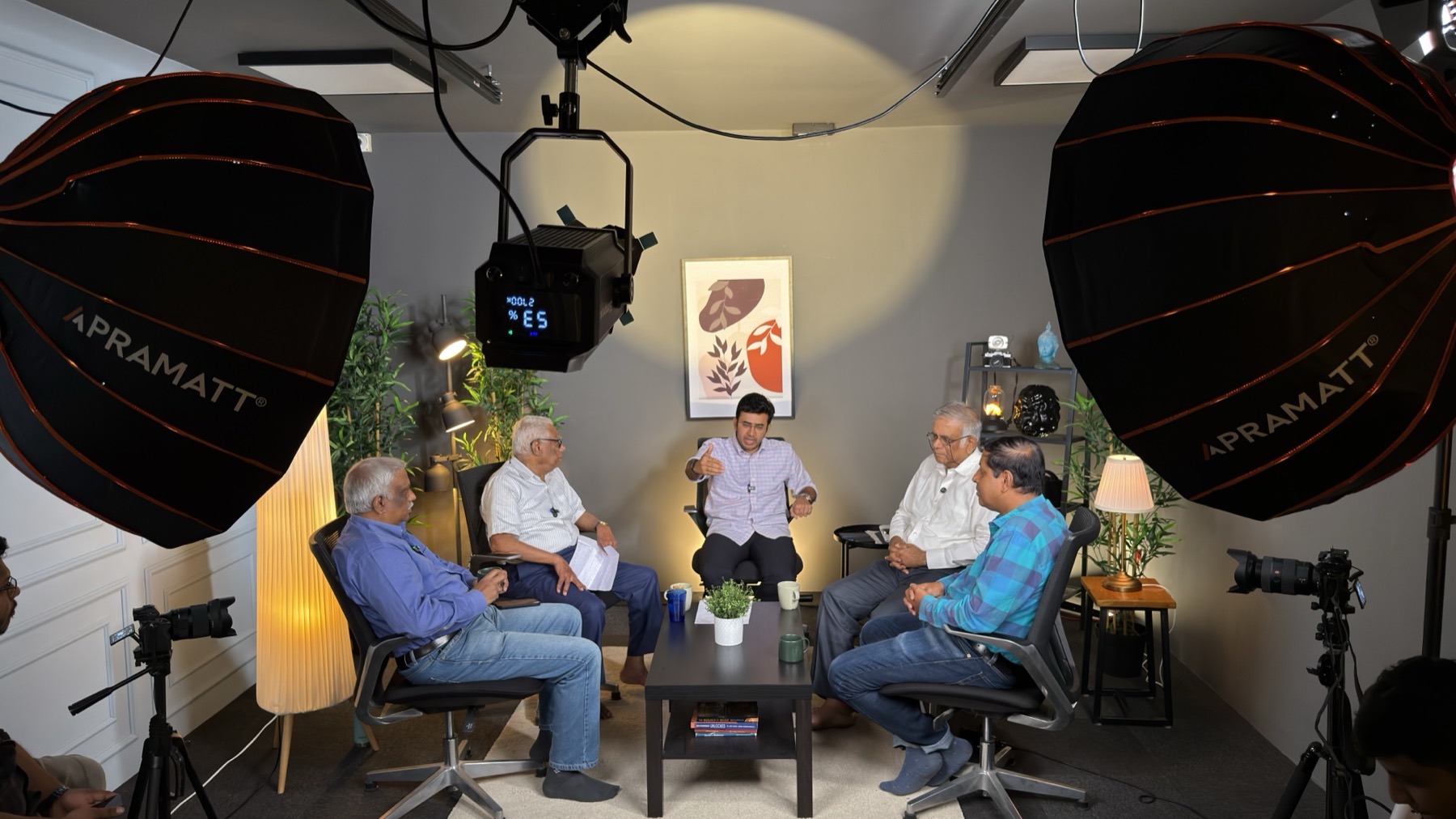 The Roundtable — a five-seater panel set mid-recording under twin softboxes